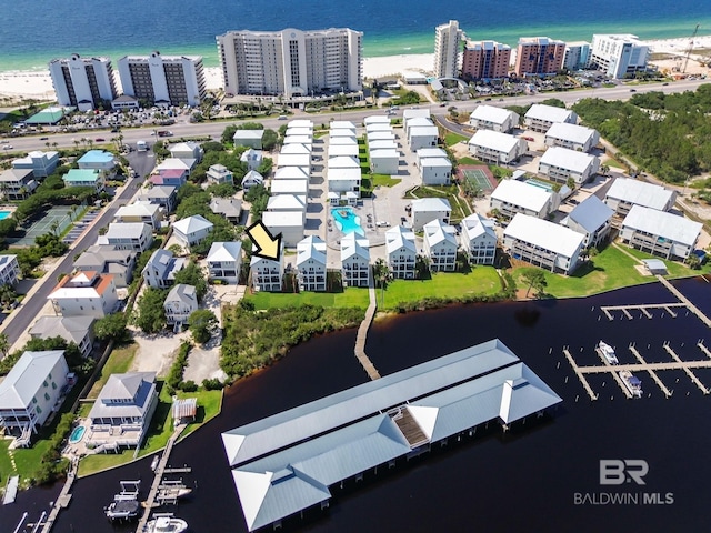 drone / aerial view featuring a water view and a beach view