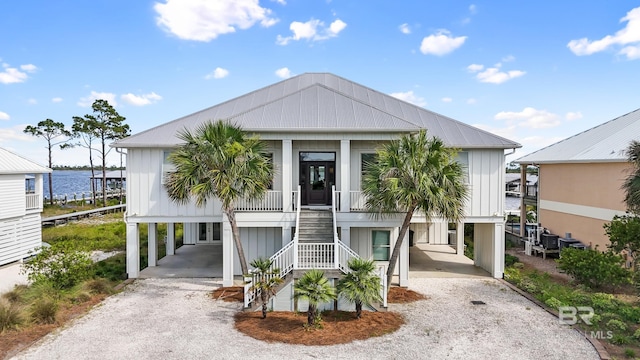 raised beach house with a carport and a porch