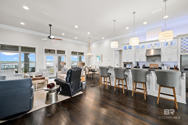 living room featuring crown molding, french doors, ceiling fan, and dark hardwood / wood-style floors