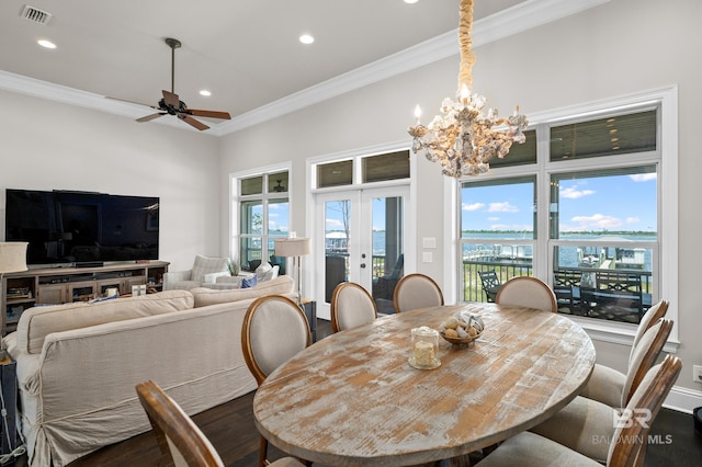 dining room with french doors, dark hardwood / wood-style flooring, ceiling fan with notable chandelier, and ornamental molding