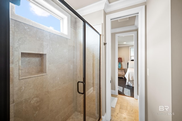 bathroom with a shower with door and ornamental molding