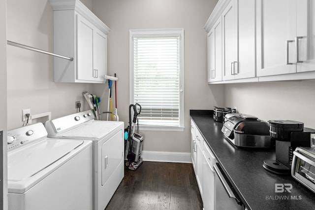 washroom featuring cabinets, washing machine and dryer, and dark wood-type flooring