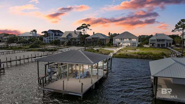 exterior space featuring a carport, a porch, and a water view