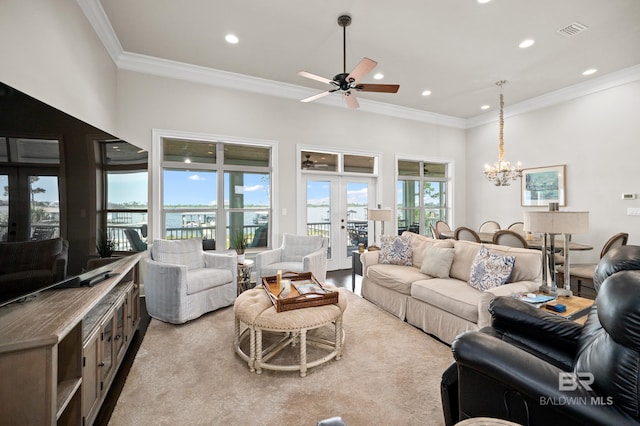 living room with crown molding, french doors, and ceiling fan with notable chandelier