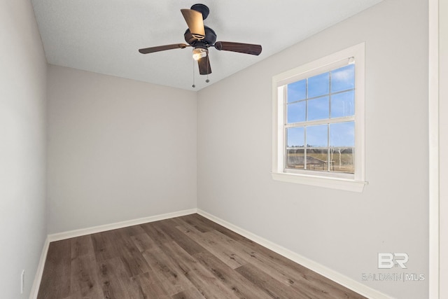 unfurnished room featuring a ceiling fan, baseboards, and wood finished floors