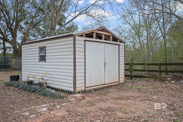 view of shed featuring fence