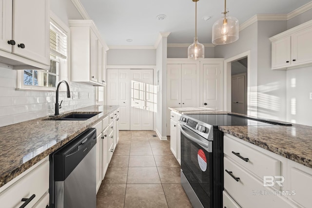 kitchen featuring white cabinetry, tasteful backsplash, appliances with stainless steel finishes, and a sink