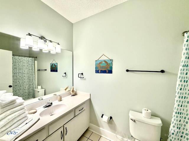 bathroom with tile patterned flooring, toilet, vanity, baseboards, and a textured ceiling