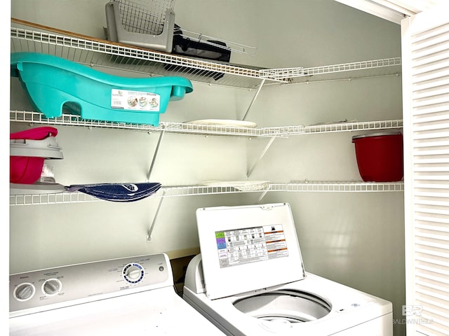 laundry area featuring separate washer and dryer and laundry area