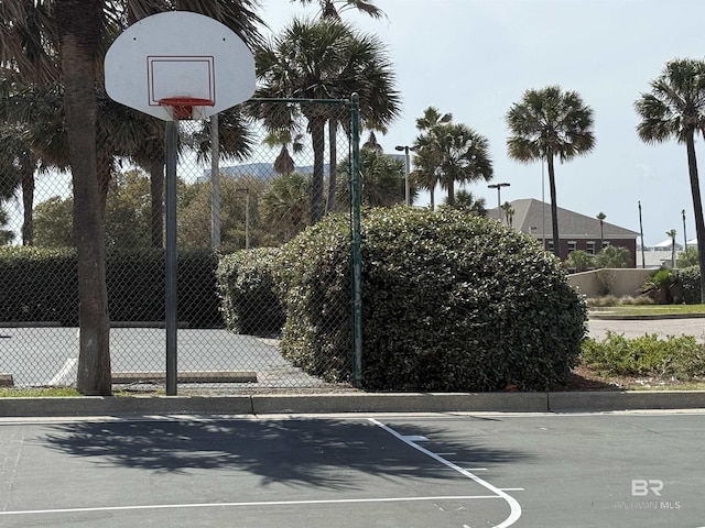 view of basketball court featuring community basketball court and fence