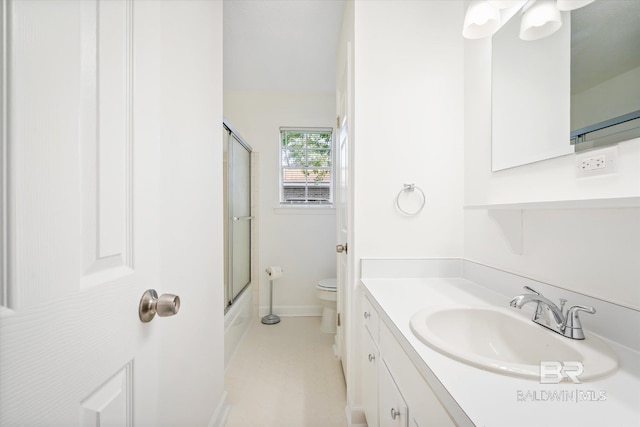 full bathroom featuring vanity, toilet, and combined bath / shower with glass door