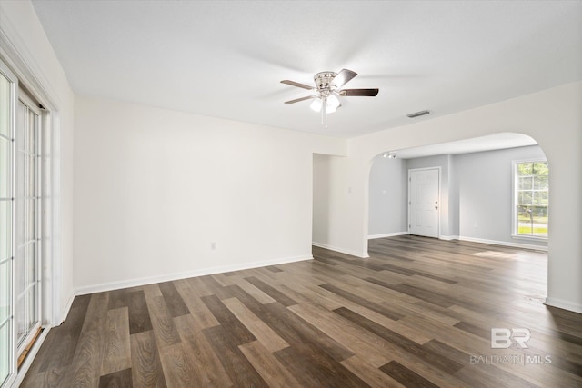 unfurnished room featuring dark wood-type flooring and ceiling fan