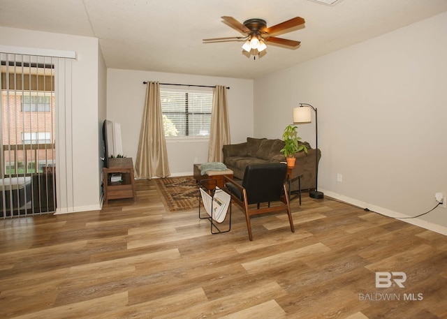 sitting room featuring ceiling fan and wood-type flooring