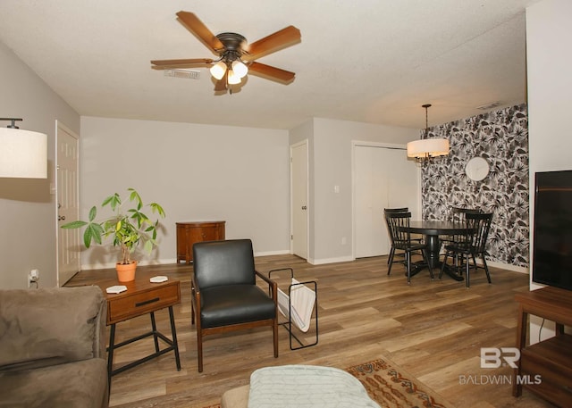 living room with hardwood / wood-style floors and ceiling fan