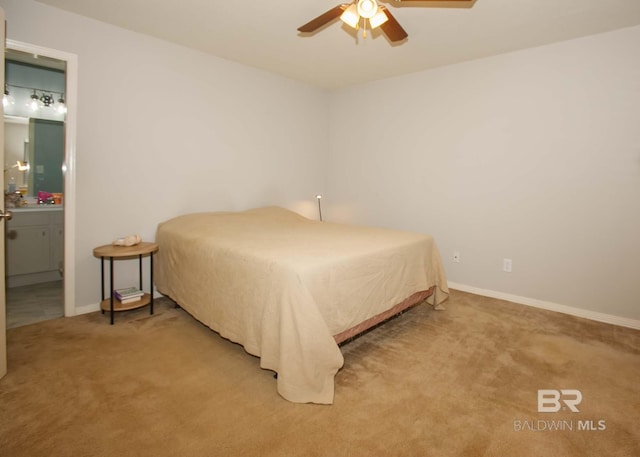 bedroom with ceiling fan, carpet, and connected bathroom