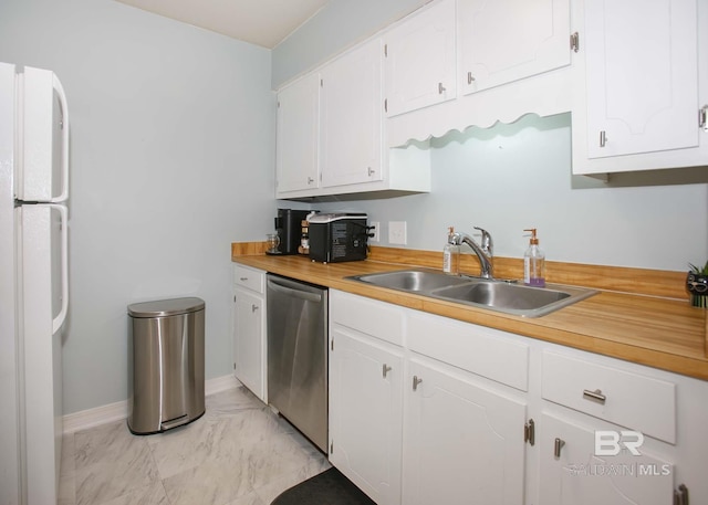 kitchen with stainless steel dishwasher, sink, white refrigerator, and white cabinets