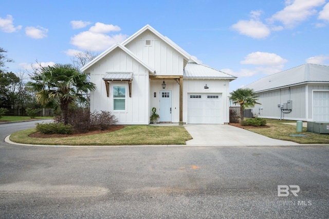 modern farmhouse with central AC unit, driveway, an attached garage, board and batten siding, and metal roof