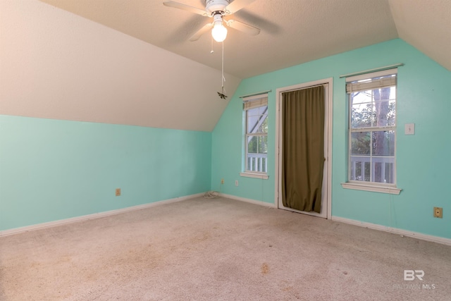 additional living space with lofted ceiling, carpet floors, and plenty of natural light