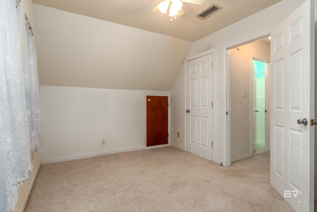 bonus room with lofted ceiling, ceiling fan, visible vents, baseboards, and carpet