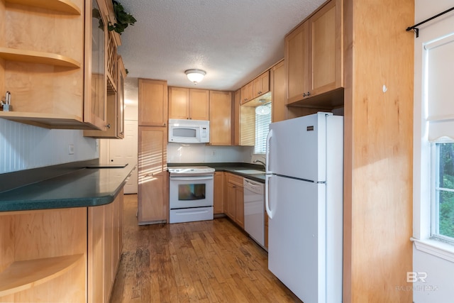 kitchen with dark wood-style flooring, open shelves, dark countertops, a textured ceiling, and white appliances