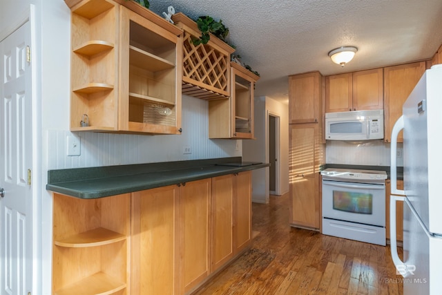 kitchen with white appliances, dark countertops, dark wood-style floors, a textured ceiling, and open shelves