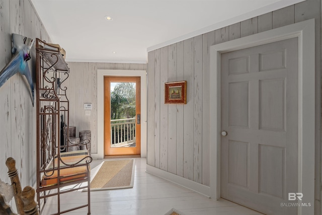 entryway with wooden walls