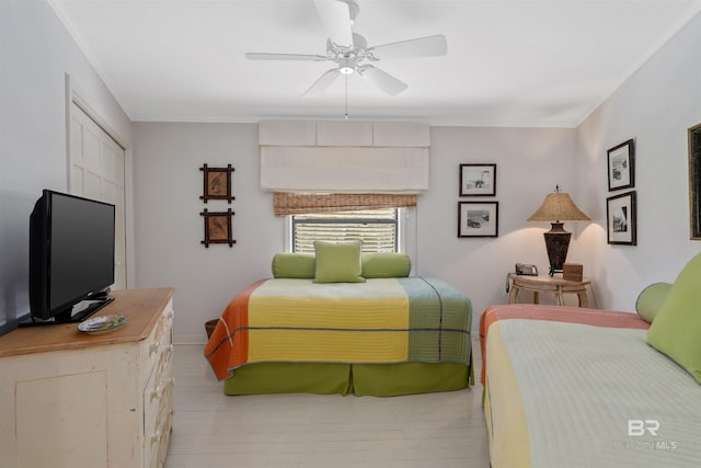 bedroom with light wood-type flooring and ceiling fan