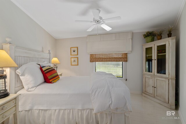 bedroom with ceiling fan and crown molding