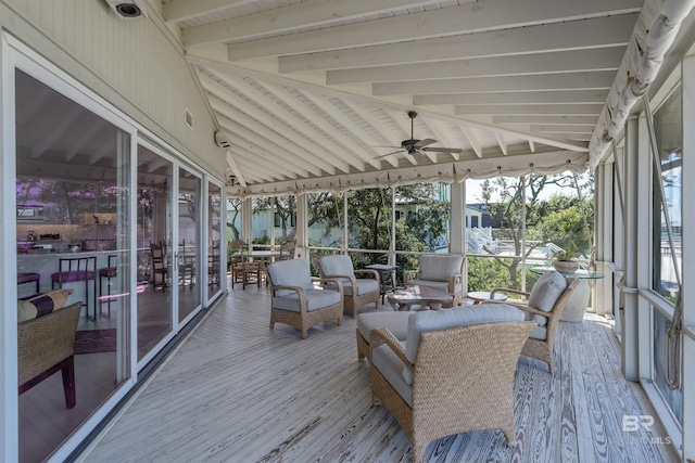 sunroom featuring lofted ceiling with beams and ceiling fan