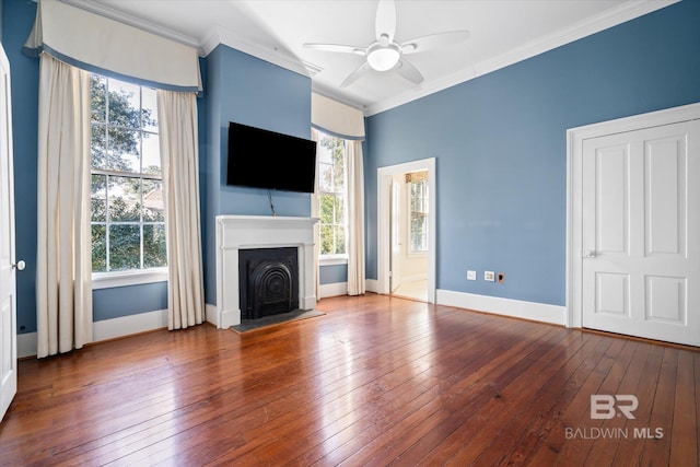 unfurnished living room with ceiling fan, ornamental molding, hardwood / wood-style floors, and a wealth of natural light