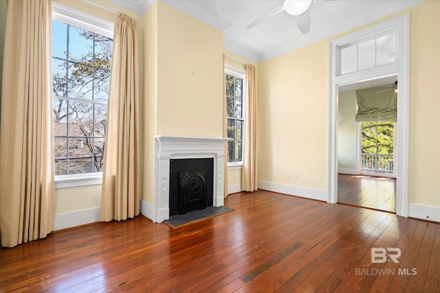 unfurnished living room featuring hardwood / wood-style floors, crown molding, and ceiling fan