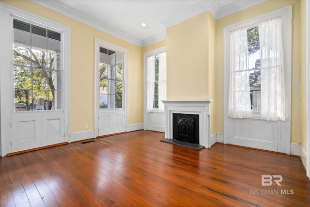 unfurnished living room featuring ornamental molding and dark hardwood / wood-style flooring