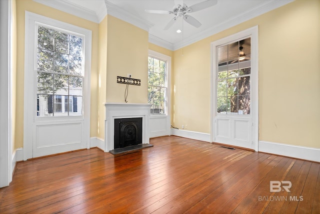 unfurnished living room featuring ceiling fan, ornamental molding, and wood-type flooring