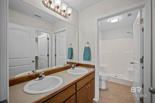 602 W 4th St, Bay Minette, AL 36507 - bathroom featuring toilet, double vanity, tile patterned floors, and a shower