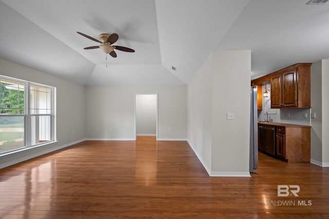 602 W 4th St, Bay Minette, AL 36507 - unfurnished living room with ceiling fan, wood finished floors, vaulted ceiling, baseboards, and a sink