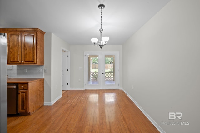 602 W 4th St, Bay Minette, AL 36507 - unfurnished dining area featuring a chandelier, light wood finished floors, french doors, and baseboards