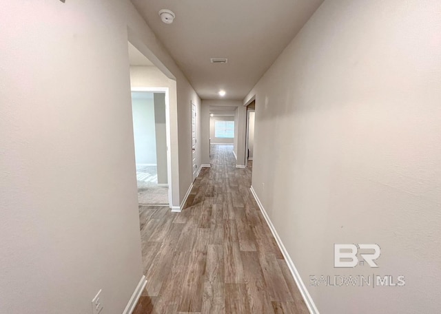 corridor with light wood-type flooring