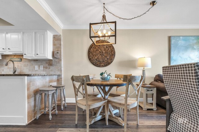 969 W Beach Blvd Unit 1306, Gulf Shores, AL 36542 - dining area with ornamental molding, a chandelier, dark wood-style floors, and baseboards