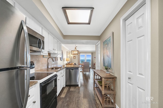 969 W Beach Blvd Unit 1306, Gulf Shores, AL 36542 - kitchen with appliances with stainless steel finishes, a sink, dark wood-style flooring, a peninsula, and white cabinets