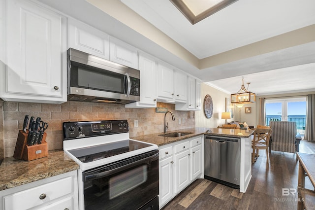 969 W Beach Blvd Unit 1306, Gulf Shores, AL 36542 - kitchen featuring stainless steel appliances, a sink, dark wood-style flooring, white cabinets, and crown molding