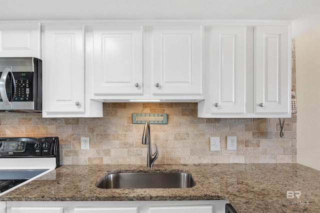 969 W Beach Blvd Unit 1306, Gulf Shores, AL 36542 - kitchen featuring stainless steel microwave, electric range oven, a sink, white cabinets, and backsplash