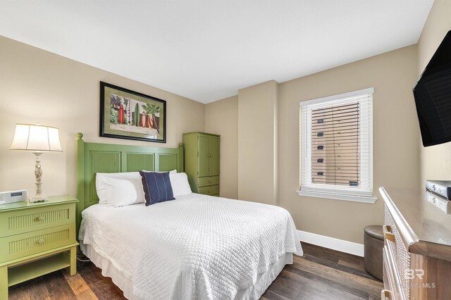 969 W Beach Blvd Unit 1306, Gulf Shores, AL 36542 - bedroom featuring baseboards and dark wood finished floors