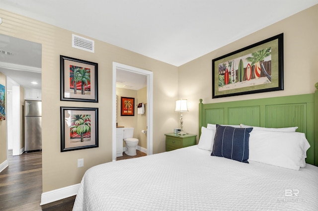 969 W Beach Blvd Unit 1306, Gulf Shores, AL 36542 - bedroom with freestanding refrigerator, baseboards, dark wood finished floors, and ensuite bathroom
