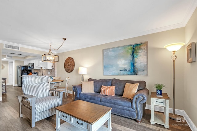 969 W Beach Blvd Unit 1306, Gulf Shores, AL 36542 - living area with wood finished floors, ornamental molding, baseboards, and a chandelier