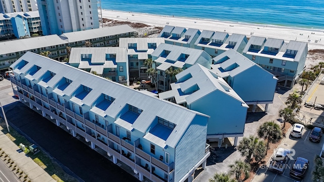 birds eye view of property with a water view and a view of the beach