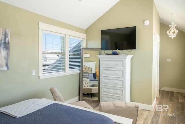 bedroom featuring vaulted ceiling, baseboards, and wood finished floors