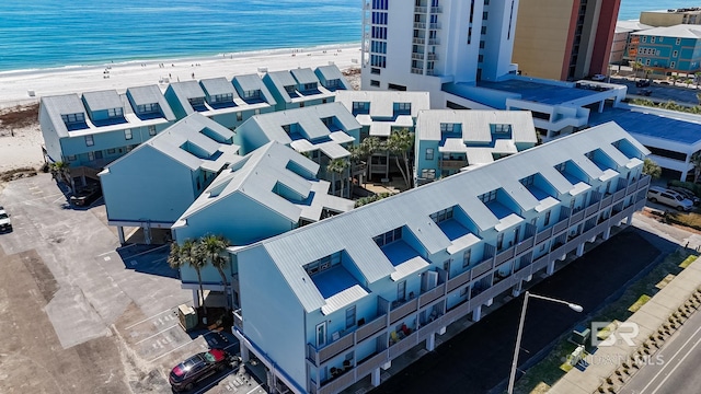 birds eye view of property with a beach view and a water view