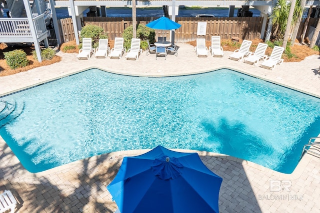 community pool featuring a patio area and fence