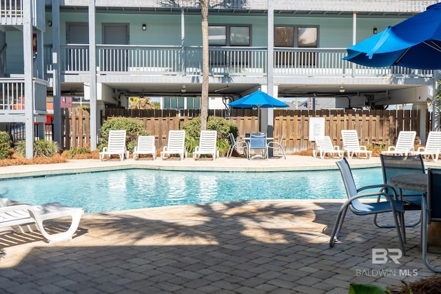 community pool featuring a patio area and fence