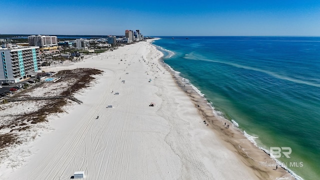 birds eye view of property with a beach view and a water view